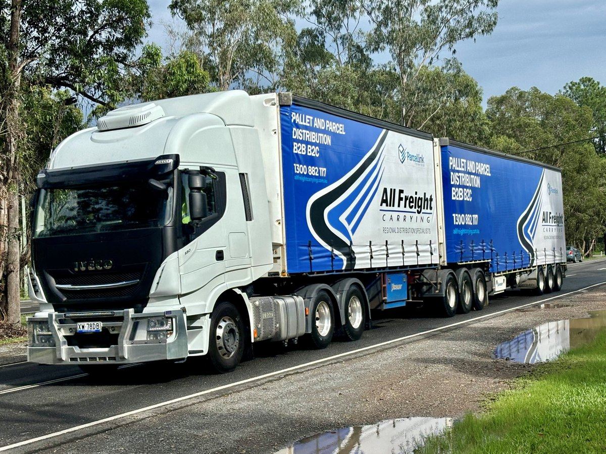 An All Freight Carrying B-double in Parcel Link livery on a Sunshine Coast highway, carrying pallets and parcels