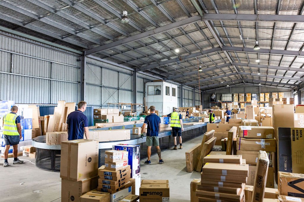 The depot crew working the sorting carousel at Yandina