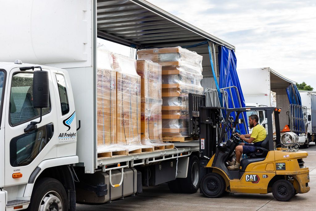 Pallets being loaded onto a rigid truck at Yandina